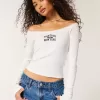 Camiseta gráfica Montauk con hombros descubiertos y ribete de encaje