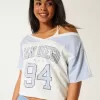 Camiseta gráfica universitaria extragrande con hombros descubiertos de San Diego