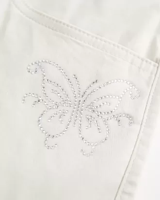 Minifalda de sarga con mariposas y brillo de tiro bajo