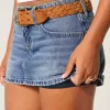Minifalda vaquera con lazo bordado y tiro bajo con curvas Minifalda vaquera con lazo bordado y tiro bajo con curvas