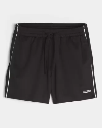 Pantalones cortos de fútbol con logotipo de punto hasta la mitad del muslo