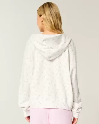 Sudadera con capucha y cremallera con estampado floral de gran tamaño