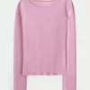 Top de manga larga con cuello oblicuo