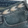 Vaqueros acampanados bordados con lavado medio y tiro ultrabajo