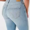 Vaqueros super ajustados de tiro alto y lavado medio con curvas Vaqueros super ajustados de tiro alto y lavado medio con curvas