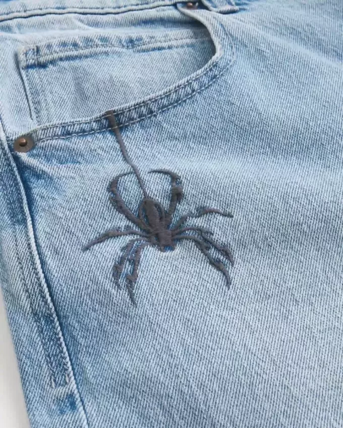 Vaqueros super holgados con estampado de araña y lavado claro Vaqueros super holgados con estampado de araña y lavado claro