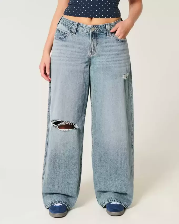 Vaqueros super holgados de talle bajo con lavado medio y rotos con curvas
