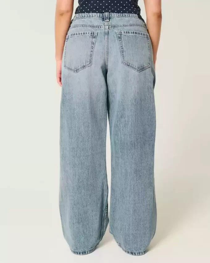 Vaqueros super holgados de talle bajo con lavado medio y rotos con curvas