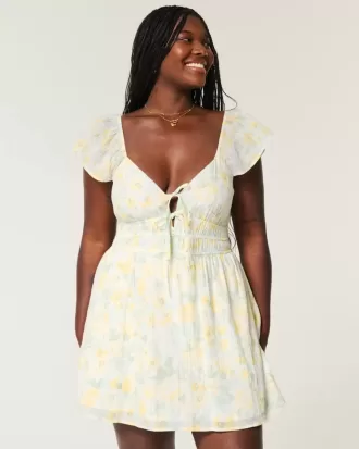 Vestido falda pantalón con doble lazo y mangas onduladas
