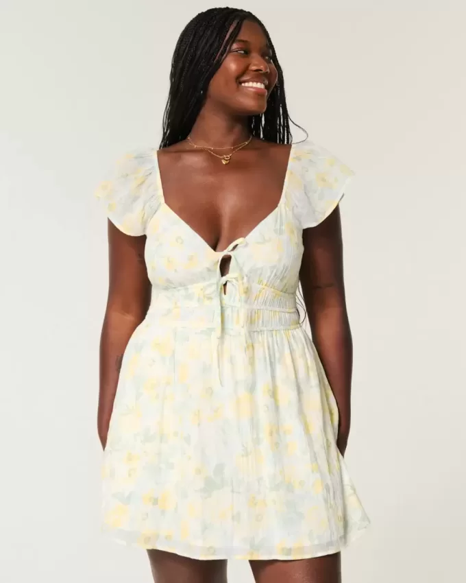 Vestido falda pantalón con doble lazo y mangas onduladas